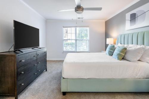 a bedroom with a bed and a flat screen tv at Landing Bellingham Park - Wilmington in Wilmington