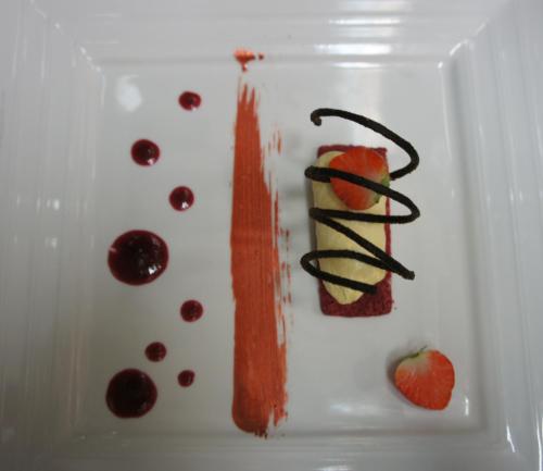 a white plate with a dessert with fruit and chocolate at Hostellerie Sainte-Cécile in Florenville