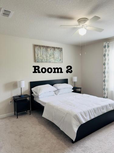 a bedroom with a bed with a room r sign on the wall at Abi home in Brandon