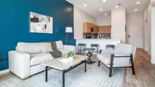 a living room with a couch and chairs and a table at Landing Incredible 1BD Pool Gym in Orlando