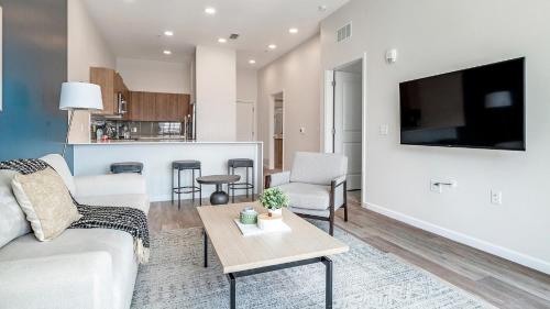 a living room with a couch and a table at Landing Incredible 1BD Pool Gym in Orlando