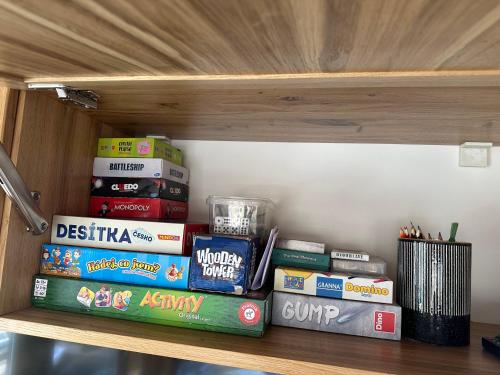 a shelf with books and other items on it at Luxury houseboat, Orlík Castle in Orlík