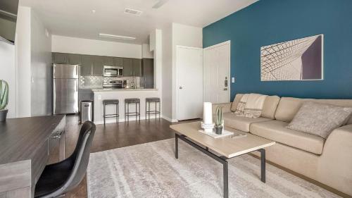 a living room with a couch and a table at Landing San Antonio Alamo Ranch Apartments in San Antonio