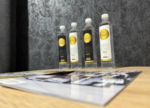 a group of five bottles sitting on top of a table at Apartman De Luxe in Tuzla