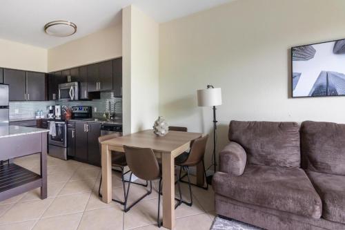 a kitchen and living room with a couch and a table at Landing at Mosaic at Miramar - Miramar in Miramar