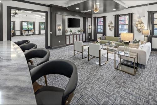 a living room with a couch and chairs at Landing at Mosaic at Miramar - Miramar in Miramar