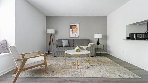 a living room with a couch and a table at Landing Stylish 1BD Pool Gym in Winston-Salem
