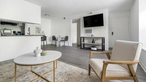 a white living room with a table and chairs at Landing Stylish 1BD Pool Gym in Winston-Salem