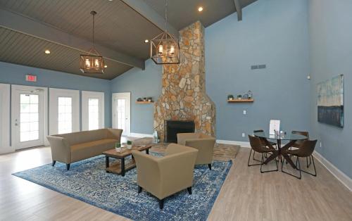a living room with a fireplace and a table and chairs at Landing Stylish 1BD Pool Gym in Winston-Salem