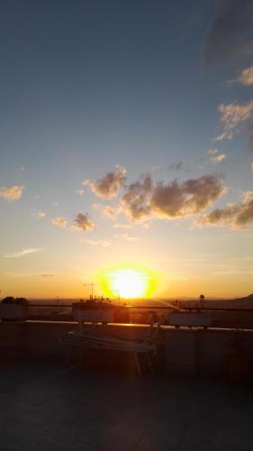 a sunset with a bench in a parking lot at Il Campanile in Tivoli