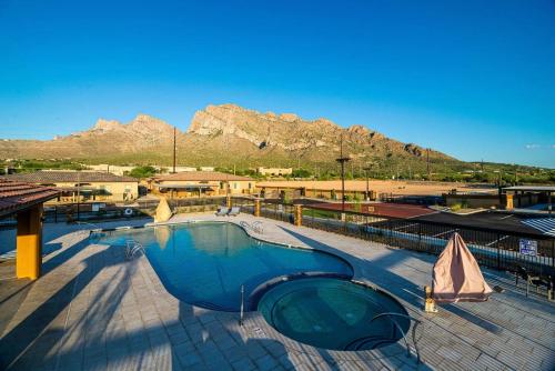 a large swimming pool with a mountain in the background at Landing at Linda Vista - Oro Valley in Oro Valley