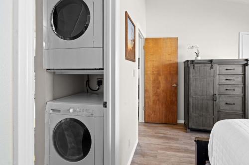 a room with a washer and dryer next to a bedroom at Hikers Hideaway - Cozy Resort Condo with Pool & More in St. George