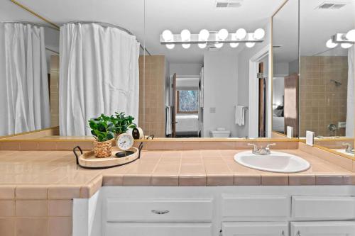 a bathroom with a sink and a large mirror at Hikers Hideaway - Cozy Resort Condo with Pool & More in St. George