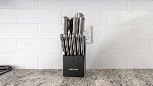 a knife block with knives in it on a counter at Landing Apartments Dry Creek - Huntsville in Huntsville