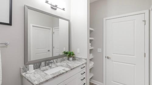 a bathroom with a sink and a mirror at Landing Apartments Dry Creek - Huntsville in Huntsville