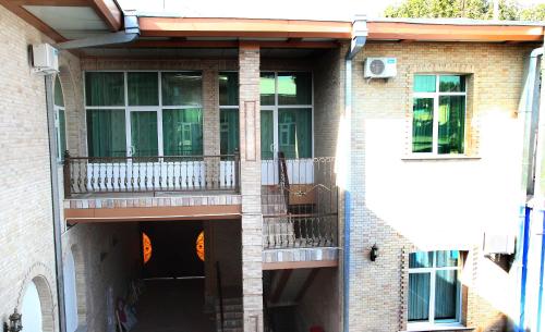 a brick building with a balcony and a window at Mixt Royal Palace in Samarkand