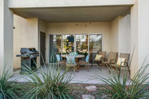 a patio with a table and chairs and a grill at Walking on Sunshine - Ground Level in St. George