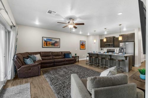 a living room with a couch and a kitchen at Walking on Sunshine - Ground Level in St. George
