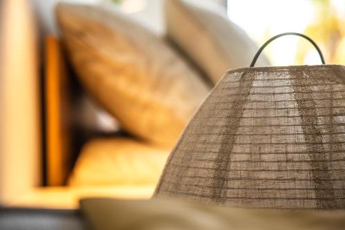 a close up of a lampshade in front of a couch at Jandia Sunrise, Your Sweet Holiday Home in Morro del Jable
