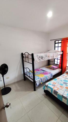 two bunk beds in a room with a window at Finca la Campechana in Cumaral