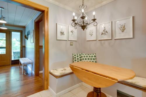 a dining room with a wooden table and a chandelier at Getaway with Guest House - 6 Mi to Lake Glenville! in Glenville