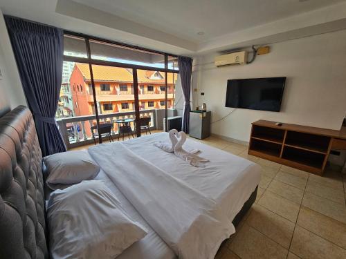 Postel nebo postele na pokoji v ubytování Candy Beach Seaview Jomtien