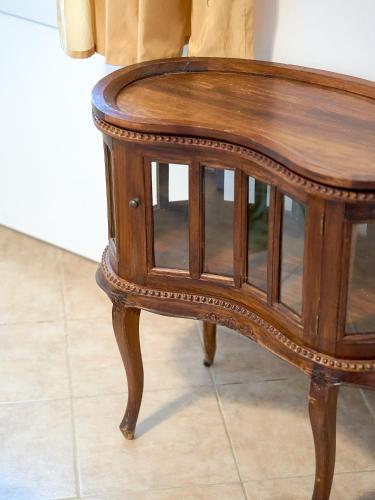 a small wooden table with glass doors on it at Eleonas in Mirodháton