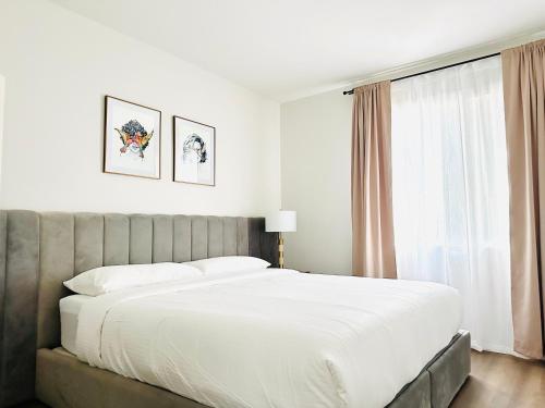 a bedroom with a large white bed and a window at The Hideaway in MDR, FREE Parking, Heated Pool in Los Angeles