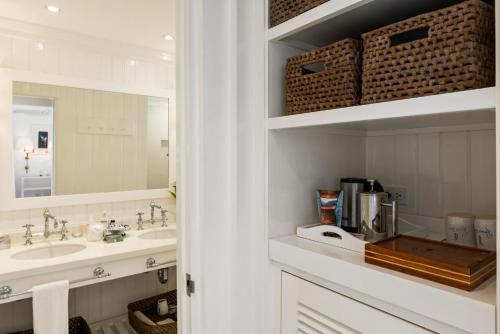 a bathroom with two sinks and a mirror at Round Hill Hotel & Villas in Montego Bay