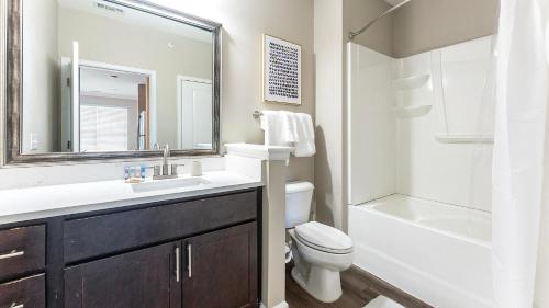 a bathroom with a sink and a toilet and a shower at Landing Apartments - Summerville in Summerville