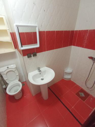 a bathroom with a toilet and a sink at Arenabeach in Martil