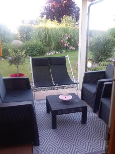 a patio with chairs and a table on a porch at Villa Barbet in Lombez