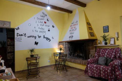 a living room with a fireplace and a chair at Escuelita Viva in Ostia Antica