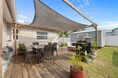 a patio with a table and chairs and a piano at Casa Playa - Private Home for 6 in St. Augustine
