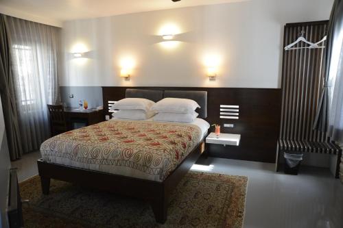 a bedroom with a bed with white pillows on it at Ayasoluk Hotel & Restaurant in Selcuk