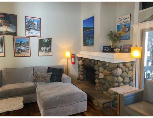 a living room with a couch and a fireplace at Lake Forest Villa Patio w BBQ in Tahoe City
