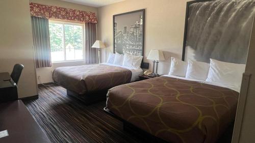 a hotel room with two beds and a window at Super 8 by Wyndham Albany in Albany