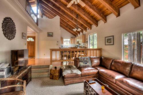 a living room with a brown leather couch at Glacier Forest Getaway HOA Access in Truckee