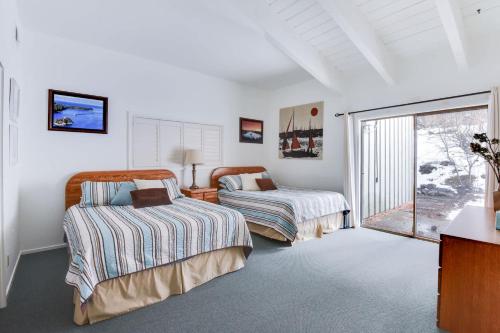 a bedroom with two beds and a window at Waters Edge Vista - HOA Pool & Pier Access in Tahoma