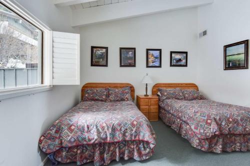 a bedroom with two beds and a window at Waters Edge Vista - HOA Pool & Pier Access in Tahoma