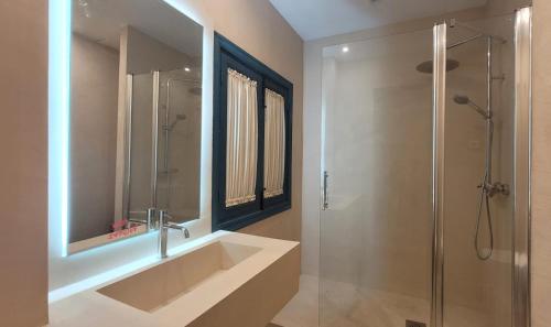 a bathroom with a large sink and a shower at El Garrotal de Medina in Carmona