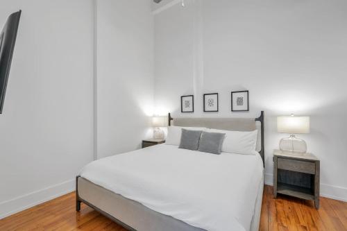a bedroom with a large white bed and two lamps at Landing Stylish 1BD Yoga Studio Gym in Greenville