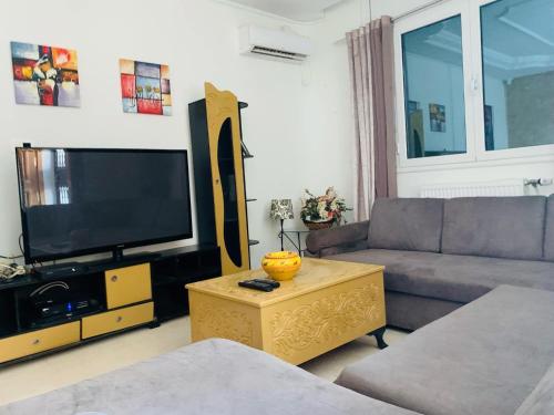a living room with a couch and a flat screen tv at Great Villa in Hammam Sousse in Hammam Sousse