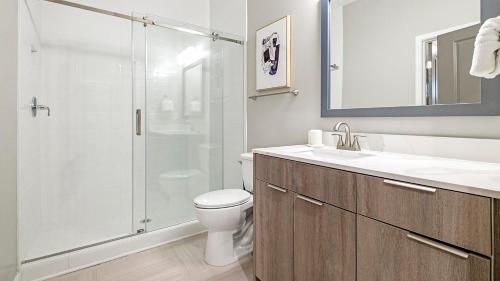 a bathroom with a shower and a toilet and a sink at Landing at The 600 - Birmingham in Birmingham