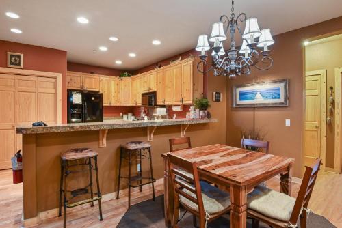 a kitchen with a wooden table and a dining room at Crystal Charm Amazing 3 BDR Condo Close to Beaches Casinos & Skiing in Crystal Bay