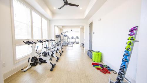 a gym with treadmills and elliptical machines at Landing at Station at Crestline - Mountain Brook in Mountain Brook