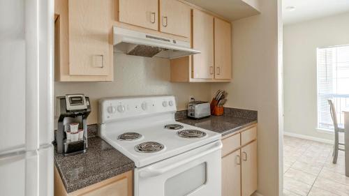 a white stove top oven in a kitchen at Landing at Settlers Ranch - Pasadena in Houston