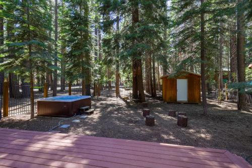 a tent and a tub in a forest with trees at Alpine Gem Near Homewood Mountain in Tahoma