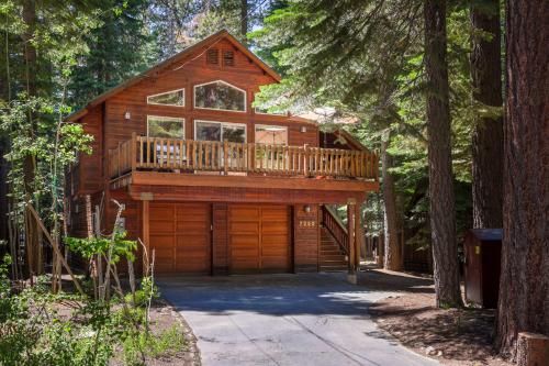 a cabin in the woods with a large deck at Alpine Gem Near Homewood Mountain in Tahoma