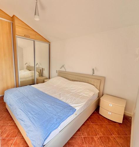 a bedroom with a large bed and a mirror at Kumbor sunny port with shared pool in Kumbor